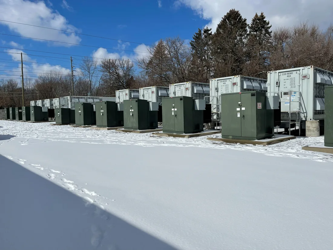 Battery storage containers and pad-mount transformers in snow.